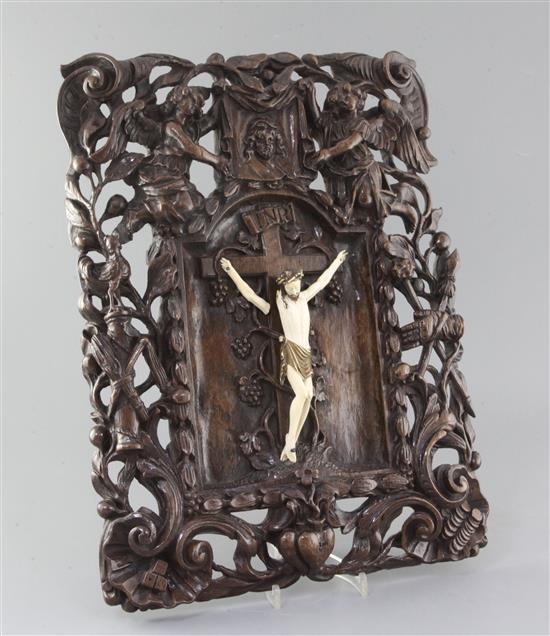 A late 18th/early 19th century Flemish walnut and ivory crucifix, 19in. width 14.5in.